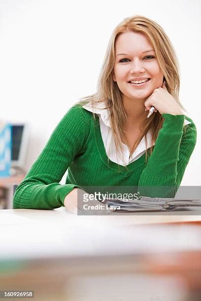 green sweater girl on desk.